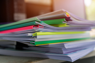 Piles unfinished documents reports files with overwork paper corner on teacher school desk office...