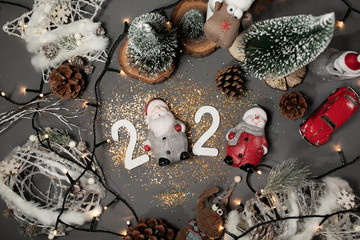 Happy New Year 2020. Symbol from number 2020 on gray background with Christmas toys