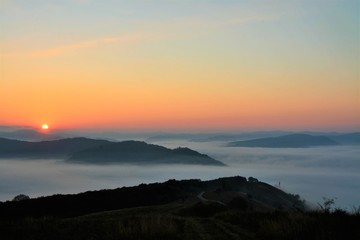 sunrise over mountains with fog in the valley