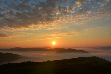 sunrise over mountains with fog in the valley