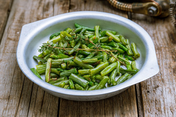 Fried green beans on old wooden table