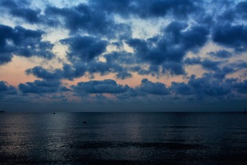 Naklejka na ściany i meble sunrise among the clouds at sea