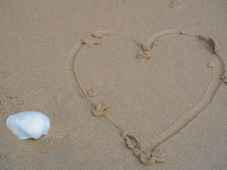 Sand surface and heart shape.