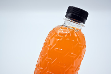 PET plastic bottles (Polyethylene terephthalate) black lid with fresh orange juice On a white background