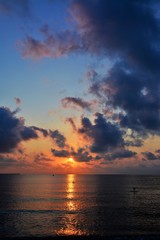 Fototapeta premium sunrise among the clouds at sea