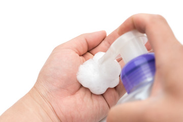 man washing hands with soapy liquid on white