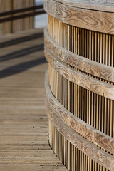 Wooden decking and railing winding into background forming pathway