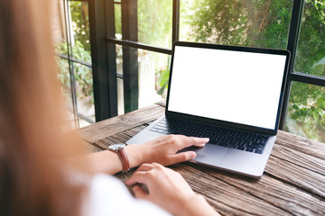 Mockup image of a woman using and touching on laptop touchpad with blank white desktop screen