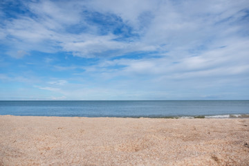 Fototapeta na wymiar Landscape image of sand on tropical beach with blue sea and sky background