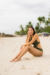 Fototapeta na wymiar Portrait beautiful asian women happy smile relax on the tropical beach sea ocean