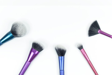 Set of colorful brushes for makeup isolated on white background.