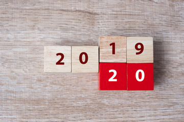 wooden cube with flip over block 2019 to 2020 word on table background. Resolution, strategy, solution, goal, business, New Year New You and happy holiday concepts