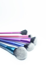 Set of colorful brushes for makeup isolated on white background.