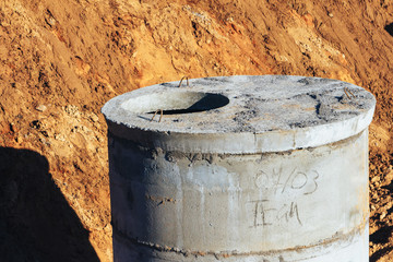 Concrete well at the construction site for water pipes