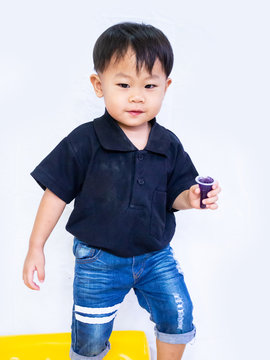 ฺBaby boy in black shait is eating delicious jelly