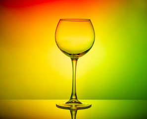 Wine glass empty on colored light background