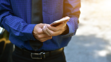 Close up businessman holding mobile smart phone