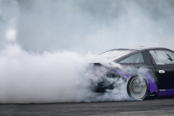 Motion blur close up drift car with  smoke from burning tires