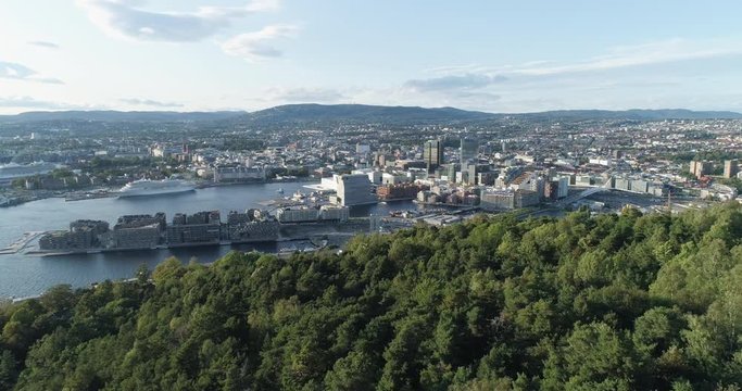 Cinema 4K drone shot with backward reveal motion and panorama view of the Oslo city line and construction in Bjoervika, a tourist attraction with the Munch museum, Soerenga and Barcode, in Norway.