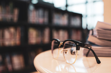 glasses on book at library and copyspace , education concept.