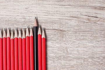 Black pencil different from crowd of red pencils. Unique Leader, strategy, independence, think different, business and success concept
