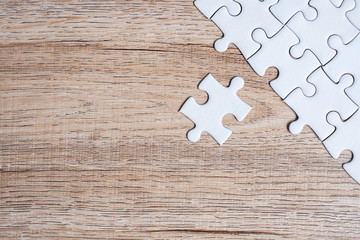puzzle pieces on wood table background. Business solutions, mission target, successful, goals, cooperation, partnership and strategy concept
