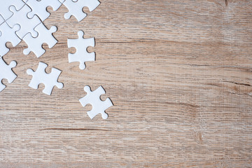puzzle pieces on wood table background. Business solutions, mission target, successful, goals, cooperation, partnership and strategy concept