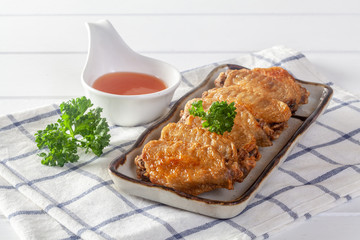Fried chicken wings on a white wooden table