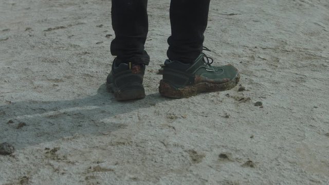 A man walking in the desert alone.
