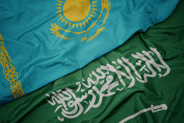 waving colorful flag of saudi arabia and national flag of kazakhstan.