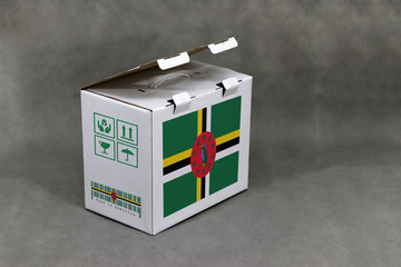 Dominica flag on white box and nation flag barcode with fragile symbol. The concept of export...