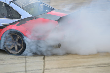 Motion blur close up drift car with  smoke from burning tires