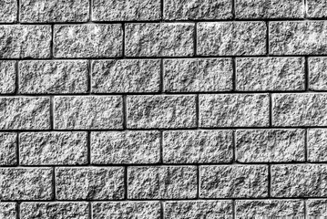 Background of brick wall with even rows of stone bricks, texture