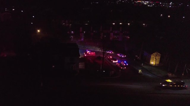 night aerial shot of ambulance and police cars