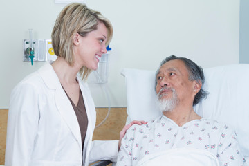 Medical Professional Comforting Elderly Asian Patient