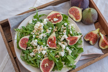 Healthy Fig salad with feta cheese, nuts and aru