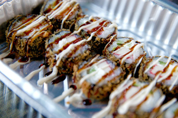 Sushi rolls sets in plastic take away box.