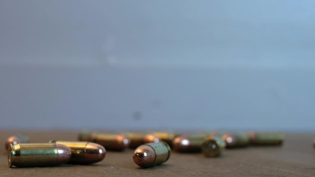 pistol ammo rolling on a table