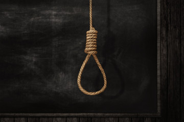 Fototapeta na wymiar Rope noose on background, a loop of rope for hanging on a Blackboard