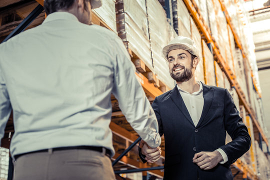 Cheerful bearded male person welcoming his partner