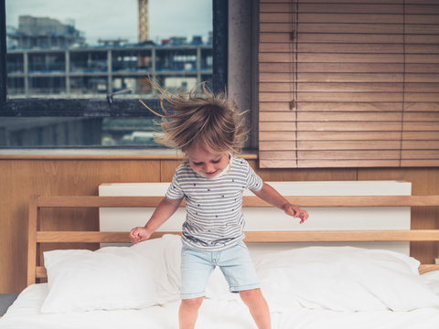 Toddler jumping on the bed