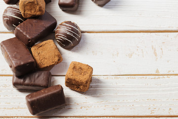 chocolate candy on white wooden background