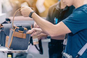 Male photographer choose camera bag that is suitable for the size of the camera used in photoghaphic store.