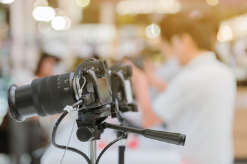 People testing professional photography cameras at Trade show on photography equipment.