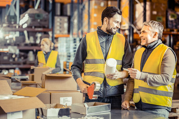Positive delighted mature man talking to his partner