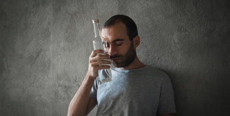 Caucasian alcoholic man with vodka.