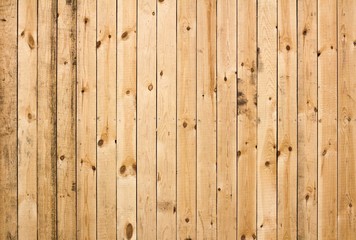 Texture of fresh wooden fence. New, light wooden boards. Boards with nails hammered into them. Close up