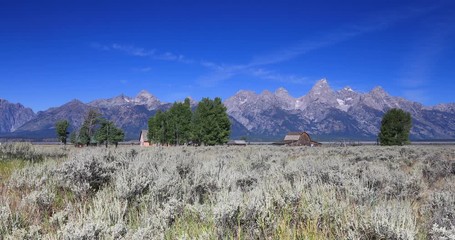 Mormon Row pioneer barn Grand Teton National Park aircraft. Pioneer settler homestead farms ranch. Historic building scenic landscape. 2.5 million visitors a year. Geography, geology, environment.