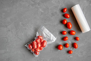 Vacuum packaging of fresh tomatoes. Flat lay. Copy space.