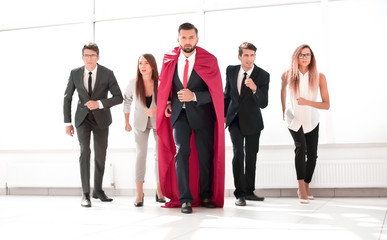 businessman superhero and his business team are stepping together.
